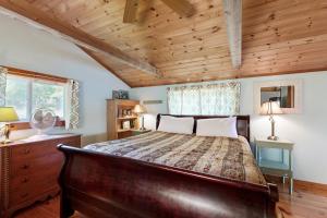 a bedroom with a bed and a wooden ceiling at Reece Cottage in Ellsworth