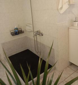a shower with a drain in a bathroom at Sunset Dafnes beach in Patra