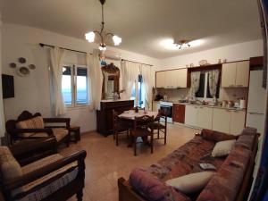 a living room with a couch and a table at Theros House Kythnos in Kithnos