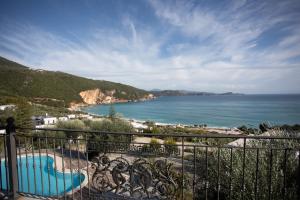 a balcony with a view of a beach and the ocean at Enjoy Lichnos Bay Village, Camping, Hotel and Apartments in Parga