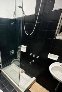 a bathroom with a shower and a sink at Casa Berutti in La Rioja +8 photos