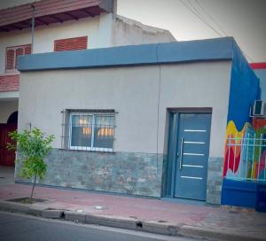 a building with a blue door on the side of it at Casa Berutti in La Rioja