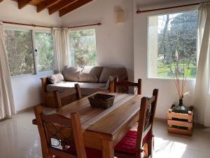 a living room with a wooden table and a couch at Pax Costa del Este in Costa del Este