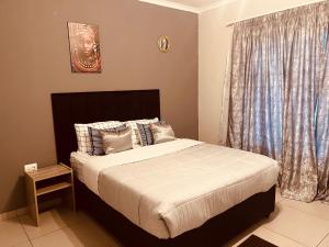 a bedroom with a large bed and a window at Mama R's unit 39 in Newcastle