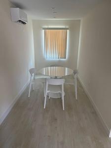 a dining room with a table and chairs and a window at San Marino guest house in Los Angeles +8 photos