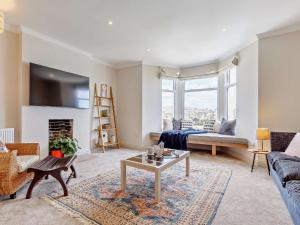 a living room with a couch and a table at 4 Bed in Fowey 82152 in Fowey