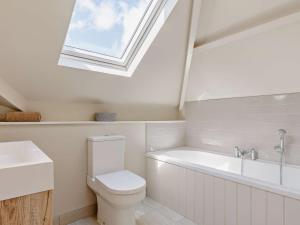 a bathroom with a toilet and a sink and a skylight at 4 Bed in Fowey 82152 in Fowey +13 photos