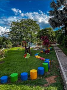 a park with a playground with colorfulools in the grass at Casa Amoblada en Conjunto Villavicencio in Villavicencio +12 photos