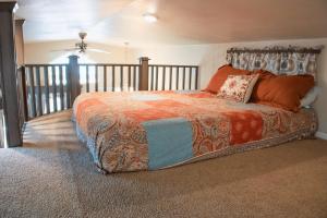 Un dormitorio con una cama con una manta naranja. en Sunset Mesa Cabin #21, en Moab