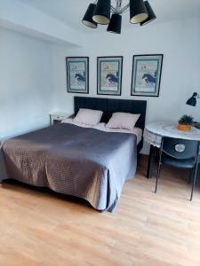 a bedroom with a large bed and a table at Happy Horse Sosnowa Góra  +13 photos
