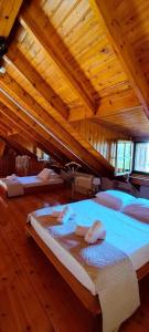 a room with three beds in a wooden building at Johnny Jo Villa in Aígio