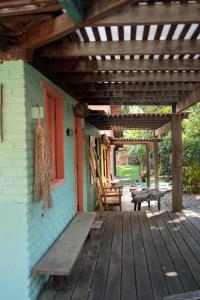 a porch of a house with a wooden pergola at Casa deck Caraíva in Caraíva +40 photos