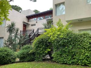 a building with bushes in front of it at Pax Costa del Este - Pax Suites in Costa del Este +14 photos