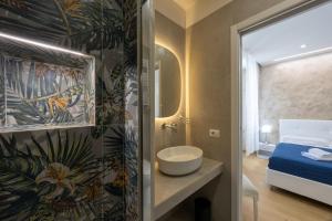a bathroom with a toilet and a sink and a bed at San Pietro Roma Suite in Rome +82 photos