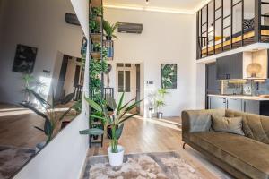 a living room with a couch and some plants at Central - Unique - High-End - Brand New in Budapest