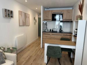 a kitchen and living room with a desk in a room at appart' grande plage in Les Sables-d'Olonne