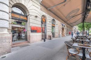 an empty street with tables and chairs outside a building at Central - Unique - High-End - Brand New in Budapest