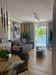 a living room with a couch and a table at Apartament MoLoo I in Ostróda