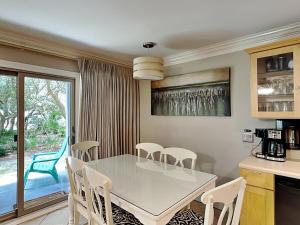 a kitchen and dining room with a table and chairs at Inlet Dunes #102 in Inlet Beach