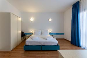Voodi või voodid majutusasutuse Hi Hotels Riva del Garda toas