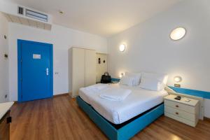Voodi või voodid majutusasutuse Hi Hotels Riva del Garda toas