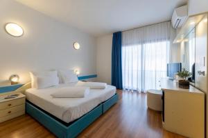 Voodi või voodid majutusasutuse Hi Hotels Riva del Garda toas