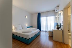 Voodi või voodid majutusasutuse Hi Hotels Riva del Garda toas