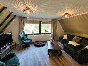 a living room with a couch and a table at Landhaus Sonnenwinkel in Brodenbach