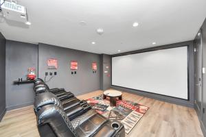 a theater room with a leather couch and a large screen at 1bd Luxury apartment near Texas Medical Center in Houston +54 photos