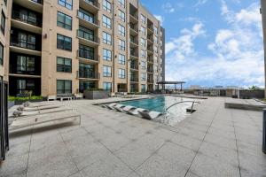 a large building with a swimming pool in front of a building at 1bd Luxury apartment near Texas Medical Center in Houston