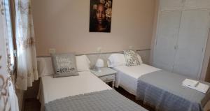 Postel nebo postele na pokoji v ubytování CASA PORTELA APARTAMENTOS