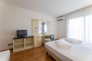 Voodi või voodid majutusasutuse Hi Hotels Riva del Garda toas