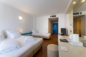 Voodi või voodid majutusasutuse Hi Hotels Riva del Garda toas