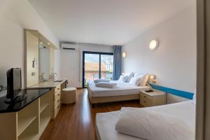 Voodi või voodid majutusasutuse Hi Hotels Riva del Garda toas