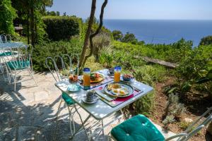 a table with food on it with a view of the ocean at Il Carrubo Capri in Anacapri