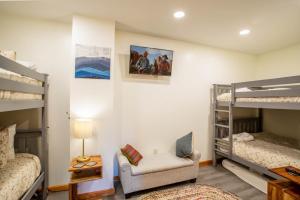 a room with two bunk beds and a chair at Skyledge in Beech Mountain