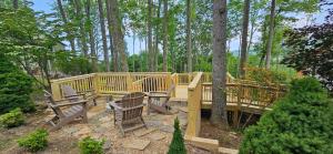 a wooden deck with chairs and a wooden bridge at Skyledge in Beech Mountain