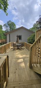 a wooden deck with a table and chairs on it at Skyledge in Beech Mountain