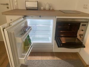 einem leeren Kühlschrank mit offener Tür in der Küche in der Unterkunft Dein Rückzugsort in der Pfalz in Ruppertsberg + 15 Fotos