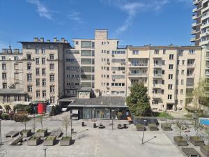 a courtyard with benches and buildings in a city at Ethno Apartments in Ljubljana