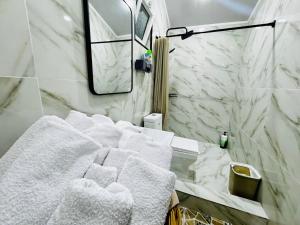 a bathroom with white towels on a sink at Mansard 91 in Sergeli Bekati +42 photos