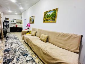 a living room with a large couch in a room at Mansard 91 in Sergeli Bekati