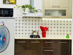 a kitchen with a white tiled counter top at Mansard 91 in Sergeli Bekati