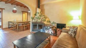 a living room with a couch and a fireplace at Casas Rurales Camino del Castaño in Galaroza