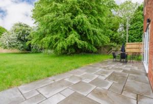 a patio with chairs and a tree in a yard at The Refuge, Wendover in Wendover