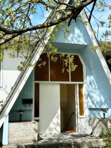 a house with a white door and a tree at Lavender house in Richmond