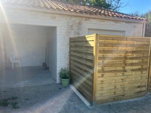 a wooden privacy fence in front of a garage at Lasko in Pornic