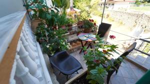 a balcony with a table and chairs and plants at ART HOUSE in Parga