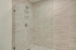 a shower with a glass door in a bathroom at Bright Gulf Coast Escape - 8 Mi to Johns Pass! in St Pete Beach
