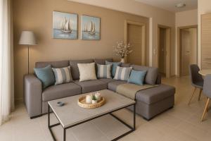 a living room with a couch and a table at Villa aspri petra rhodes in Rhodes Town